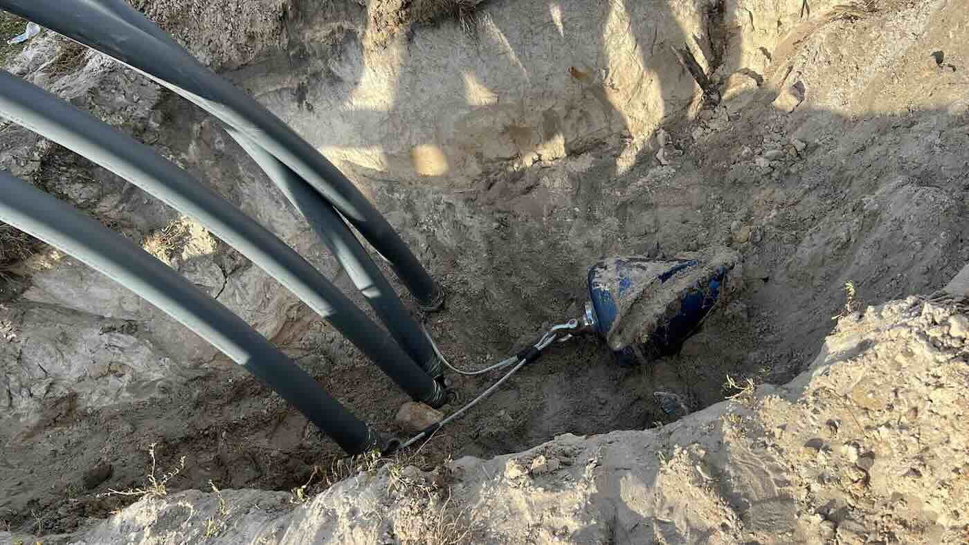 Directional drill placing conduit for fiber and water services in a new subdivision.